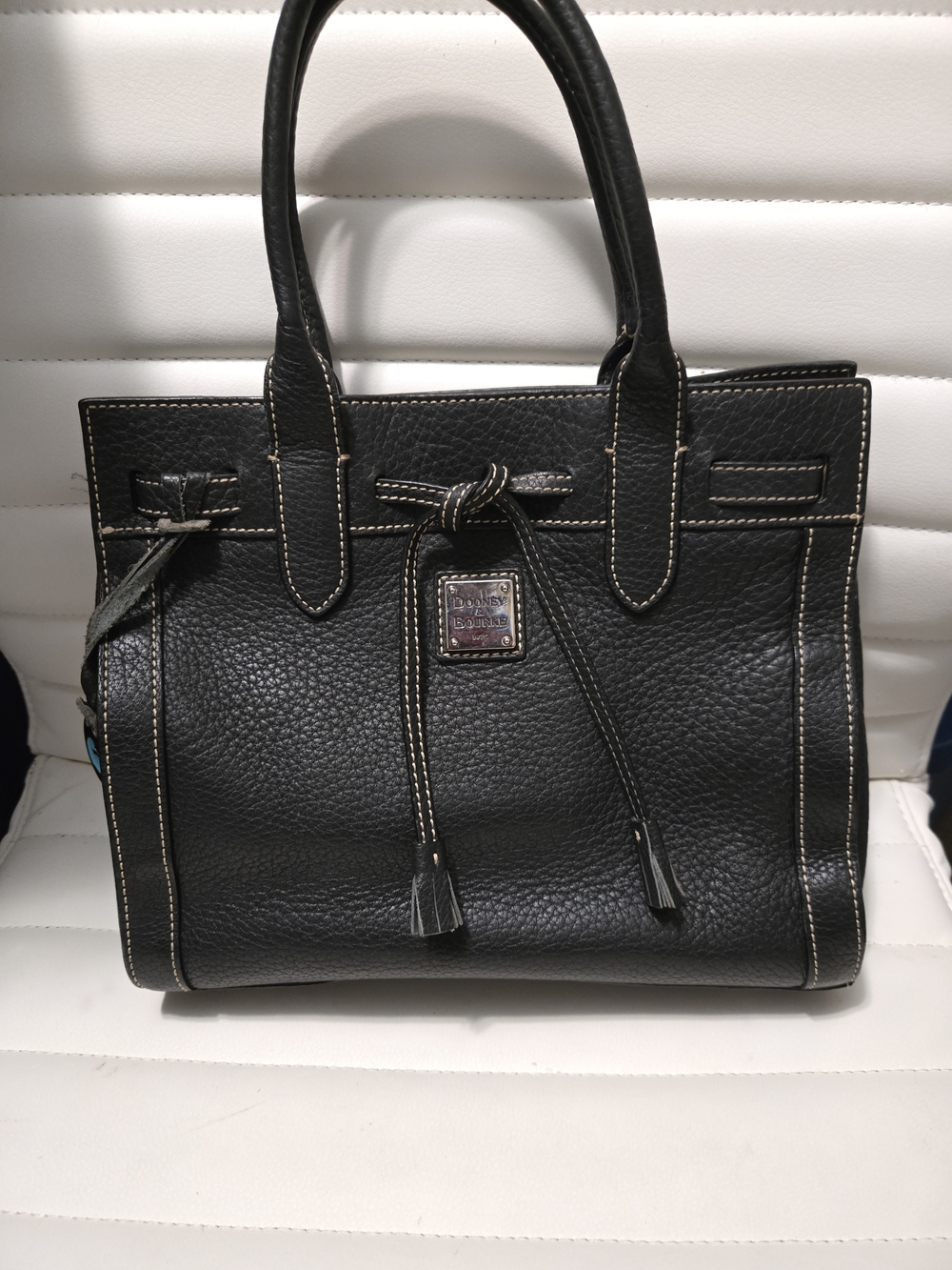 East-West Tassel Tote with contrast stitching and silver-tone hardware. EUC